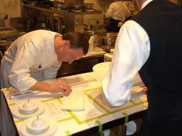 Photo of two people working in the French Laundry kitchen