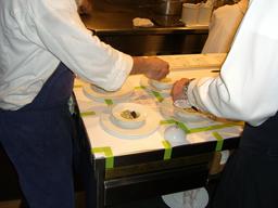 Photo of two cooks preparing the Oysters and Pearls dish at the French Laundry